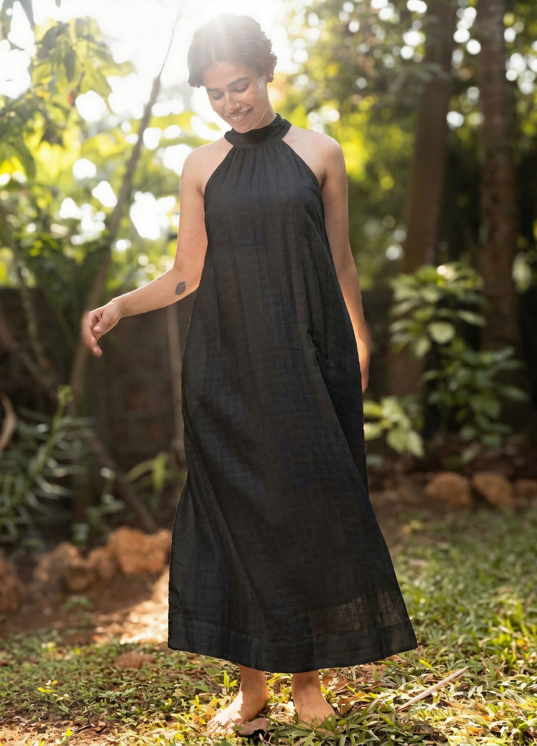 Black sleeveless halter-neck maxi dress with a relaxed, flowing silhouette